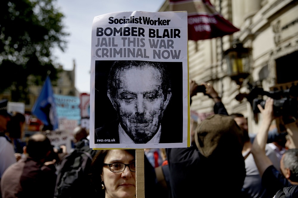 倫敦6日抗議民眾手持抨擊前首相布萊爾的字牌（湯森路透）