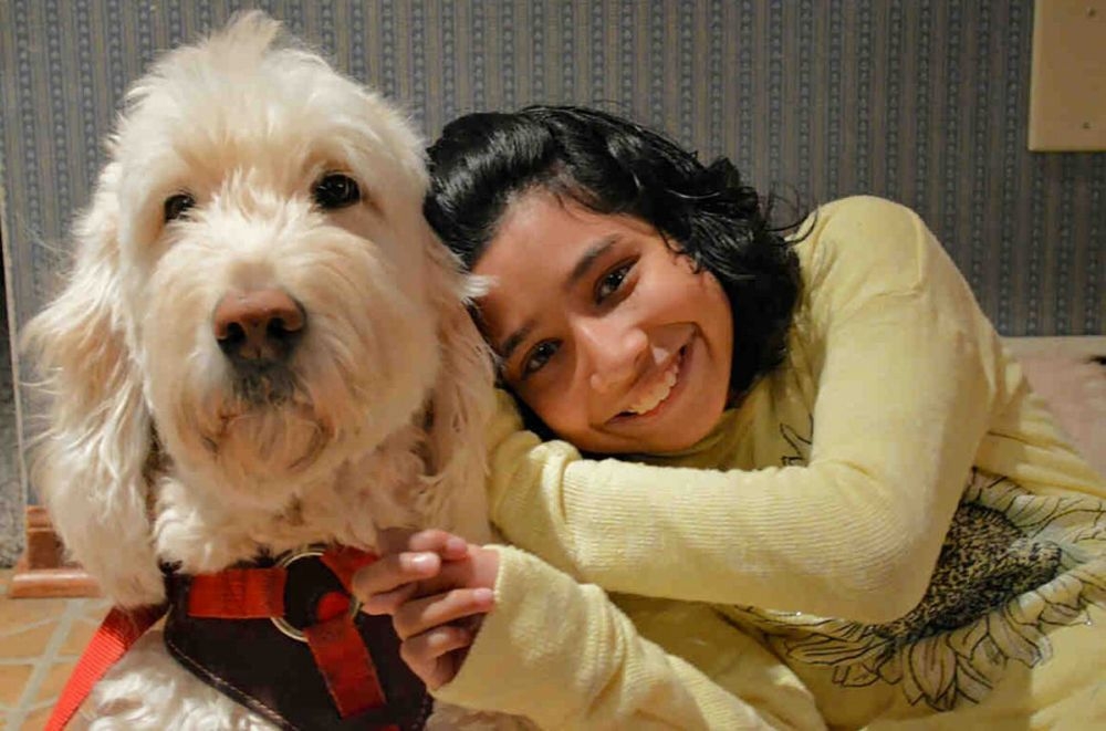 美國身心障礙學童芙萊與她的狗Wonder。（湯森路透）