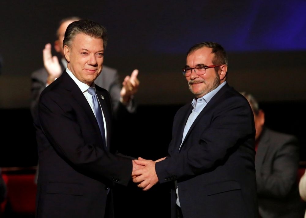 哥倫比亞總統桑托斯與哥倫比亞革命武裝陣線（FARC）首領朗多諾（Rodrigo Londono）11月24日簽暑新版和平協議。  （湯森路透）