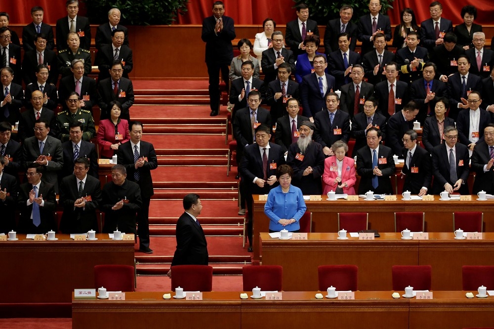 習近平13日出席中國全國政協會議，會中決議報告再度強調反台獨與反港獨政策。（湯森路透）