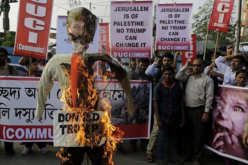 巴勒斯坦民眾13日焚燒象徵美國總統川普的人偶。（AP）