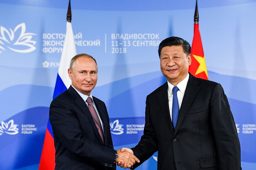 俄羅斯總統普京（左）、中國國家主席習近平（右）。（湯森路透）