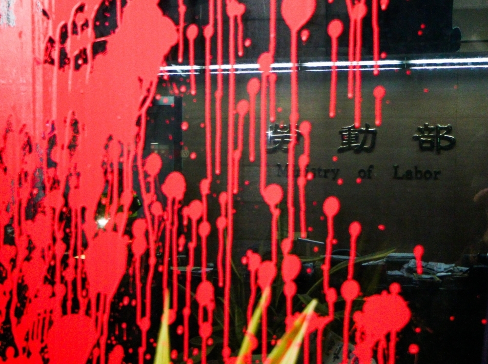 「2016工人鬥總統」團體23日凌晨夜襲潑漆勞動部，更寫上「血汗政策」四字。（攝影者：曾原信）