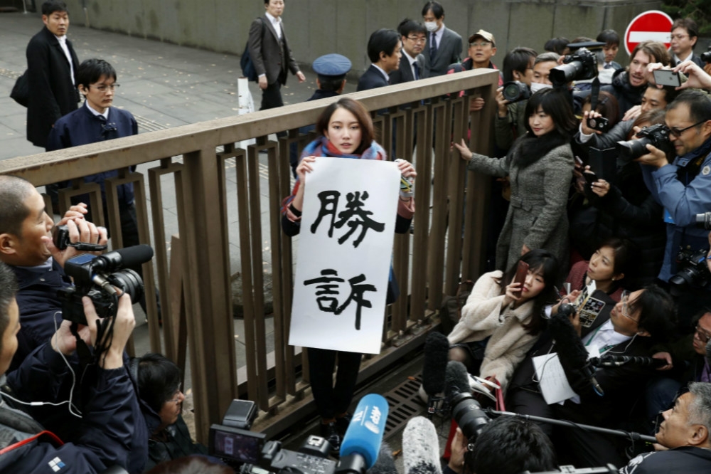 纏訴多年後、日本女記者伊藤詩織（中間持海報者）在性侵案訴訟獲勝。（湯森路透）