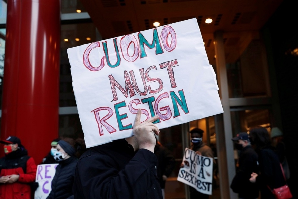 3月10日示威者在紐約曼哈頓區的紐約州長古莫（Andrew Cuomo）辦公室外高舉下台標語。（湯森路透）