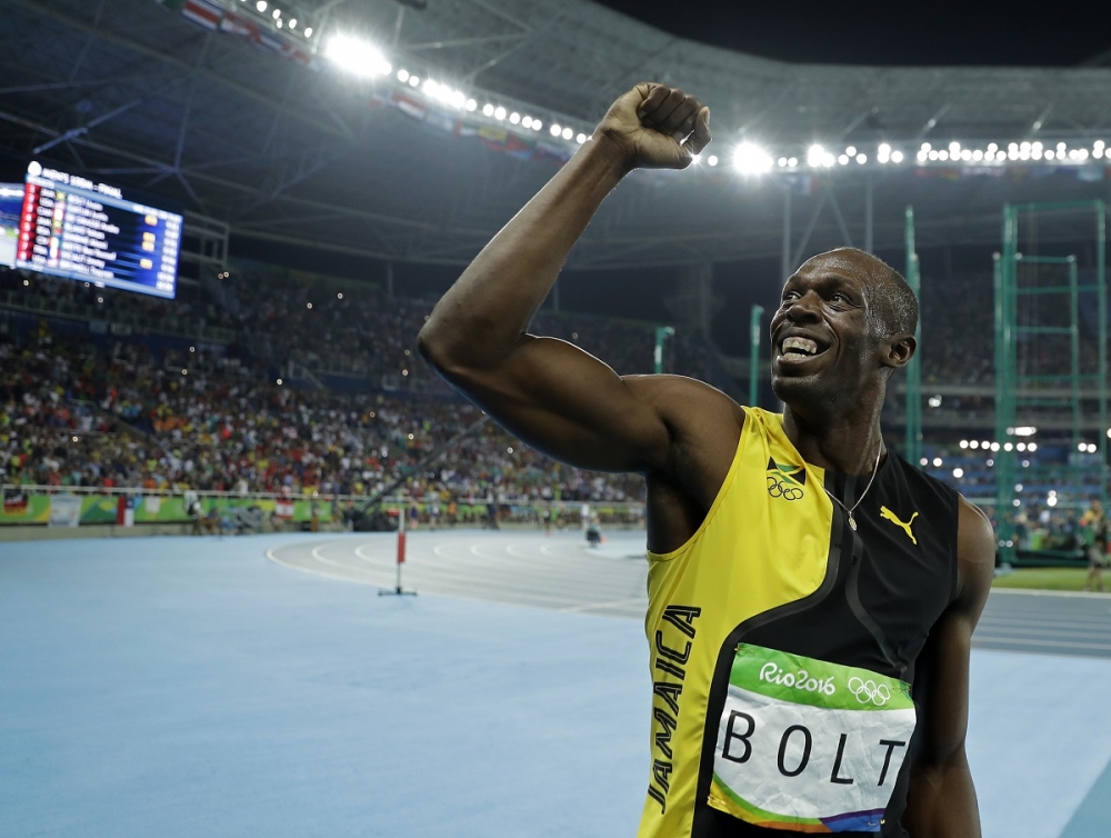牙買加田徑運動員柏特（Usain Bolt）連續拿下男子100公尺徑賽第3面奧運金牌。（美聯社）