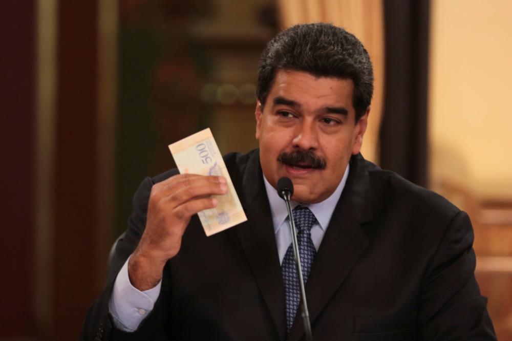 委內瑞拉馬杜洛17日展示即將通行的新貨幣「主權玻利瓦」。（湯森路透）
