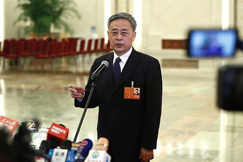 郭樹清9日在十三屆全國人大一次會議的部長通道接受媒體採訪。（中新社）