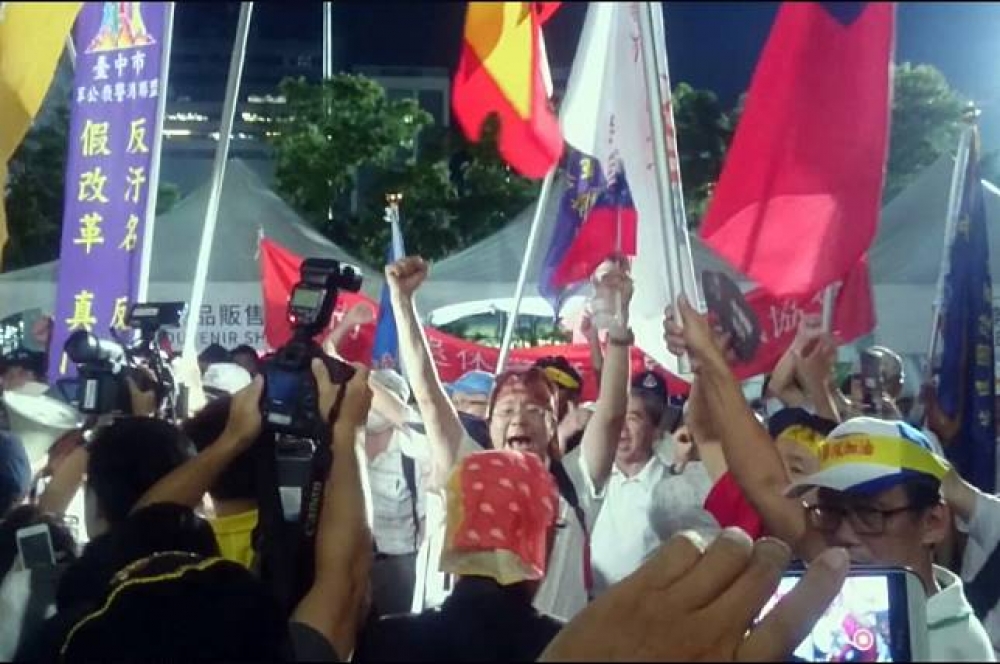 世大運開幕遭反年改團體抗議，目前警方已逮捕「南台灣抗暴聯盟」發言人顏才仁及墨鏡男李姓男子。（攝影：羅佳蓉）