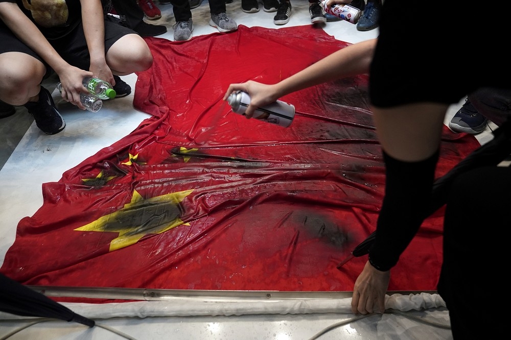 香港抗議民眾以噴漆破壞中國國旗。（湯森路透）