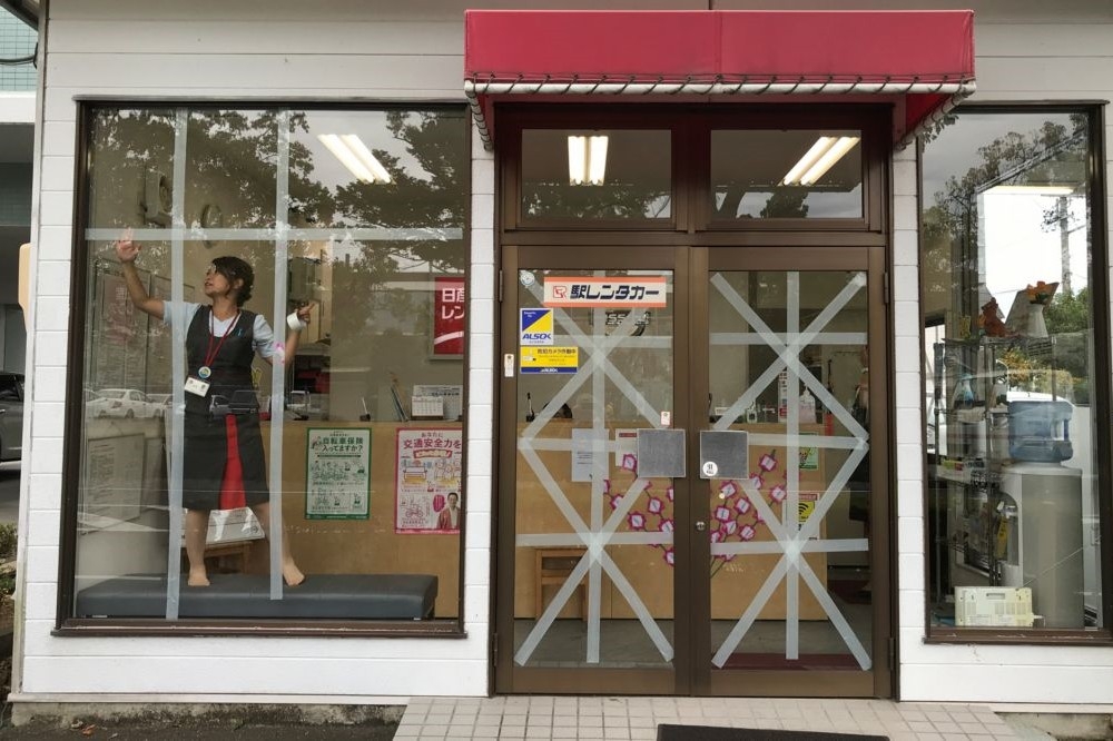日本東北掛川市1名女店員正在進行防颱準備。（湯森路透）