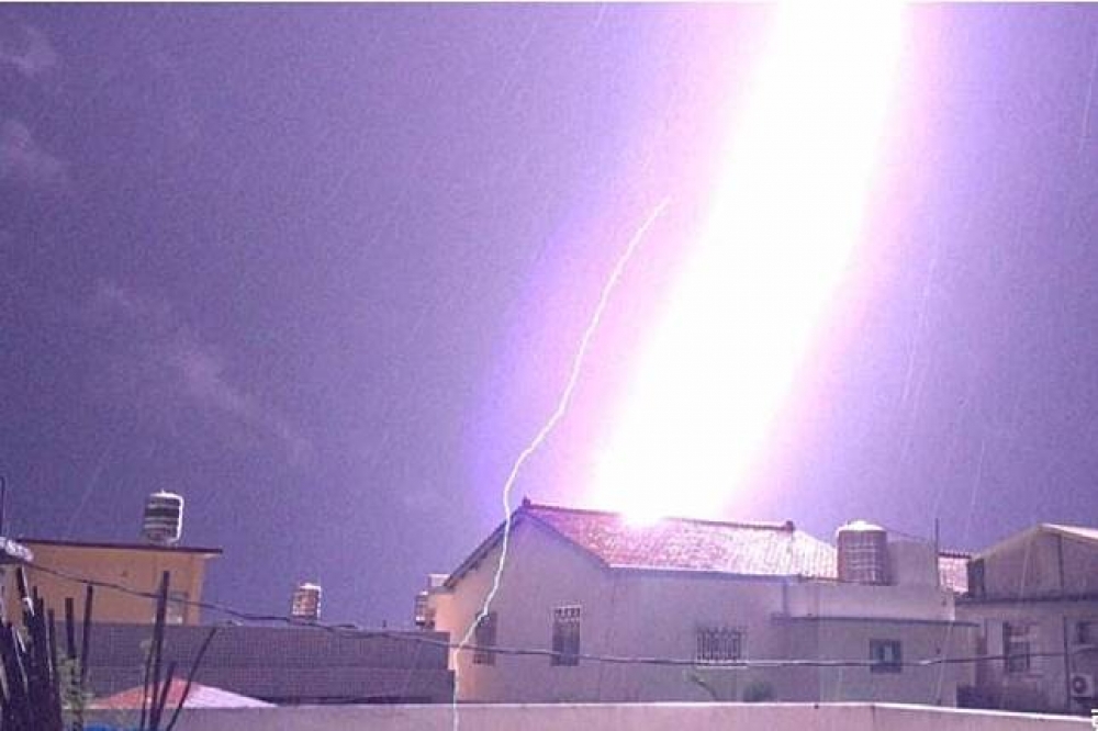 彰化縣有一名攝影師拍下「閃電瞬間」，照片中，只見紫色閃電劈下，天空瞬間被染成一片亮白色，氣勢驚人！（賴仲由授權提供）