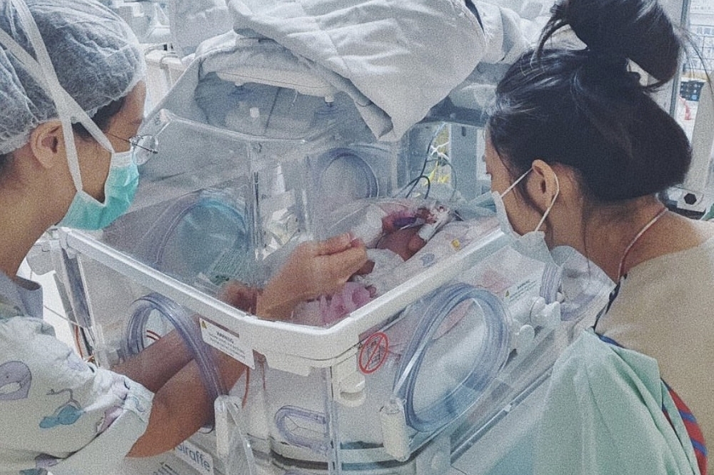 余文樂老婆王棠云（右）在保溫箱前看著早產的女兒，滿是不捨心疼。（取自王棠云Instagram）