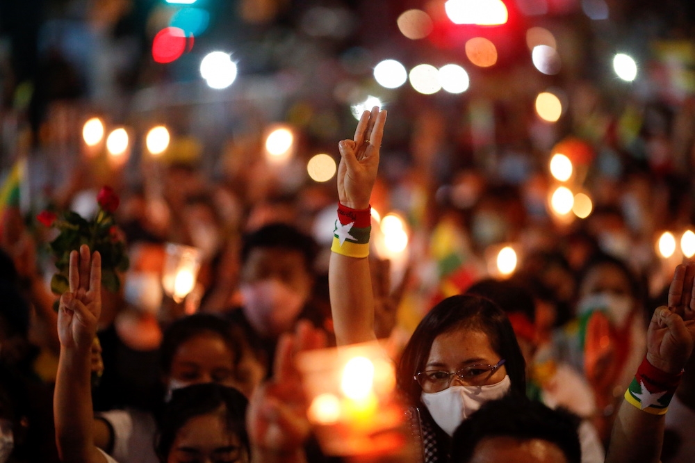 民眾4日在曼谷聯合國大樓前高舉三指，悼念逝世示威者。（湯森路透）