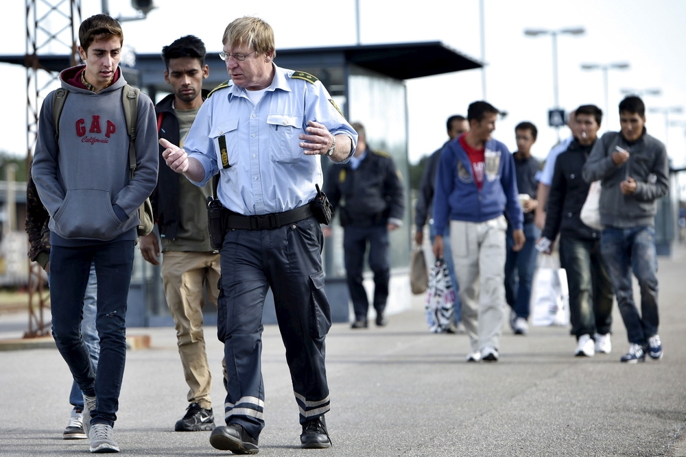 大批敘利亞難民通過陸路抵達丹麥，與該國邊境駐警進行交談。（湯森路透）