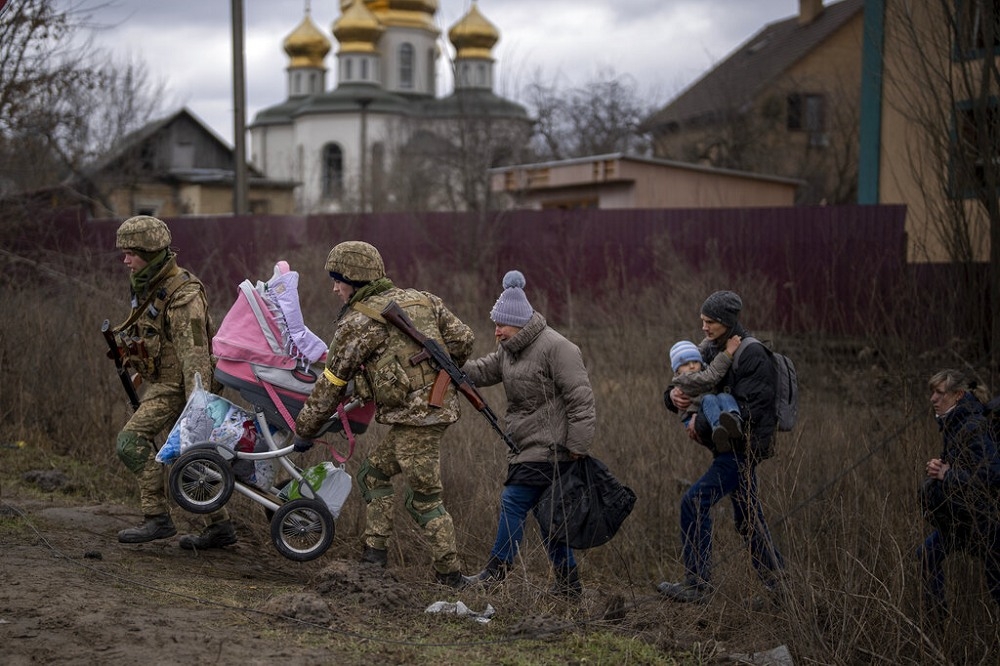 烏克蘭軍人協助民眾撤離家園。（美聯社）