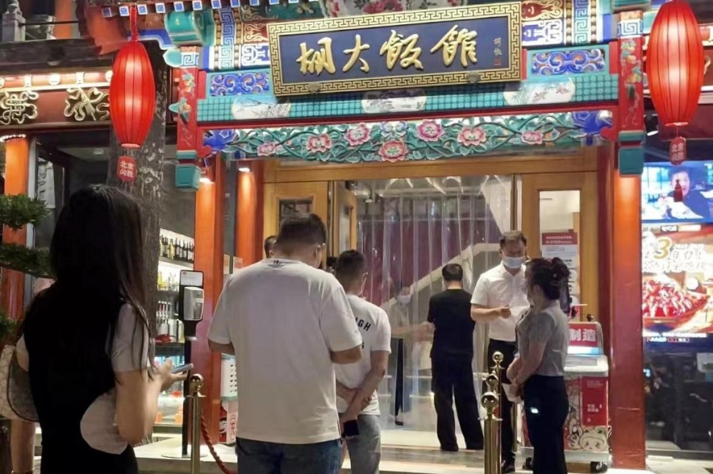 北京民眾5日深夜在餐廳前排隊，準備入用享用美食。（取自新京報網站）