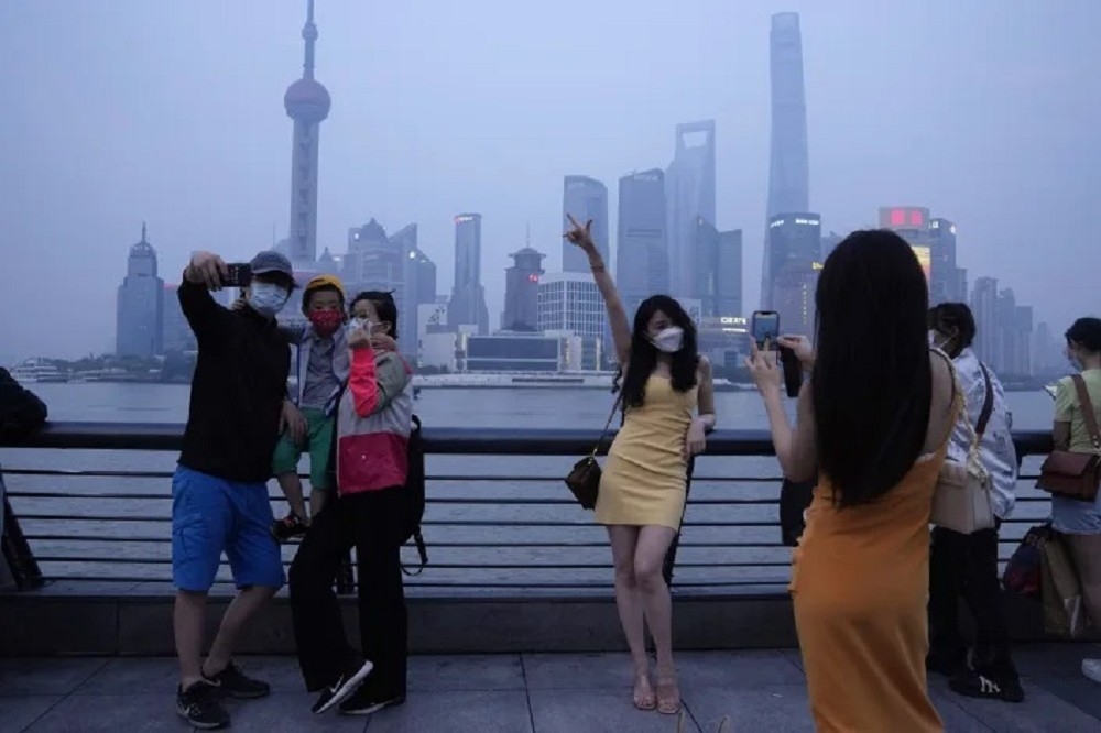 上海疫情趨緩，民眾在上海外灘遊玩、拍照。（美聯社）