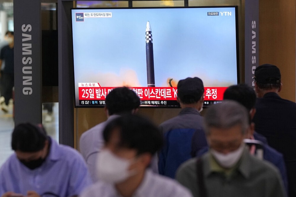 首爾火車站內，民眾看著電視播報北韓發射飛彈的新聞。（美聯社）