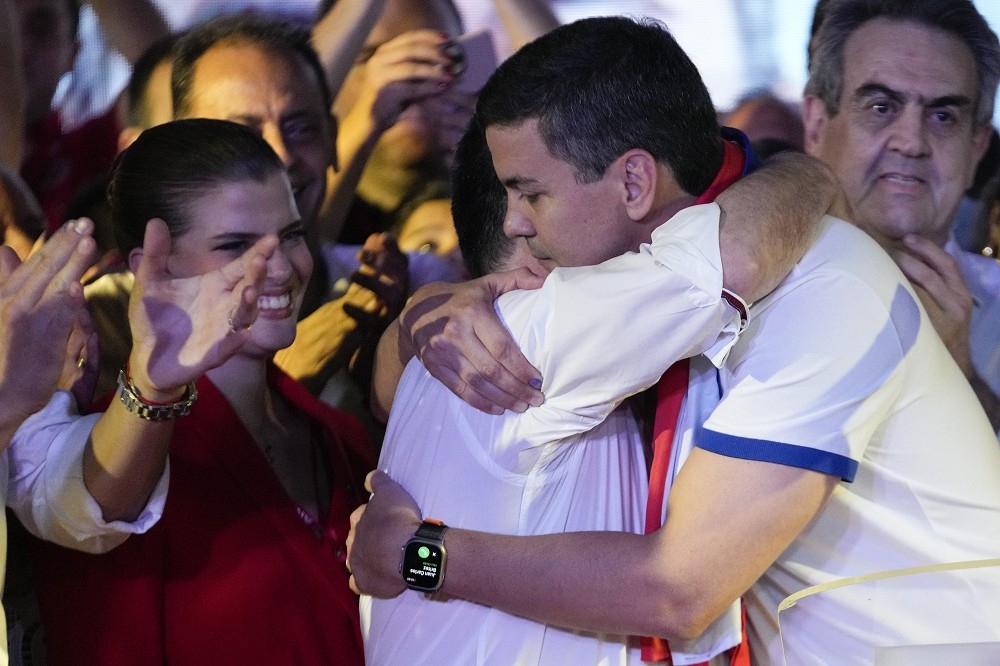 貝尼亞（右）與巴拉圭前總統卡提斯互擁，慶祝在大選中勝出。（美聯社）