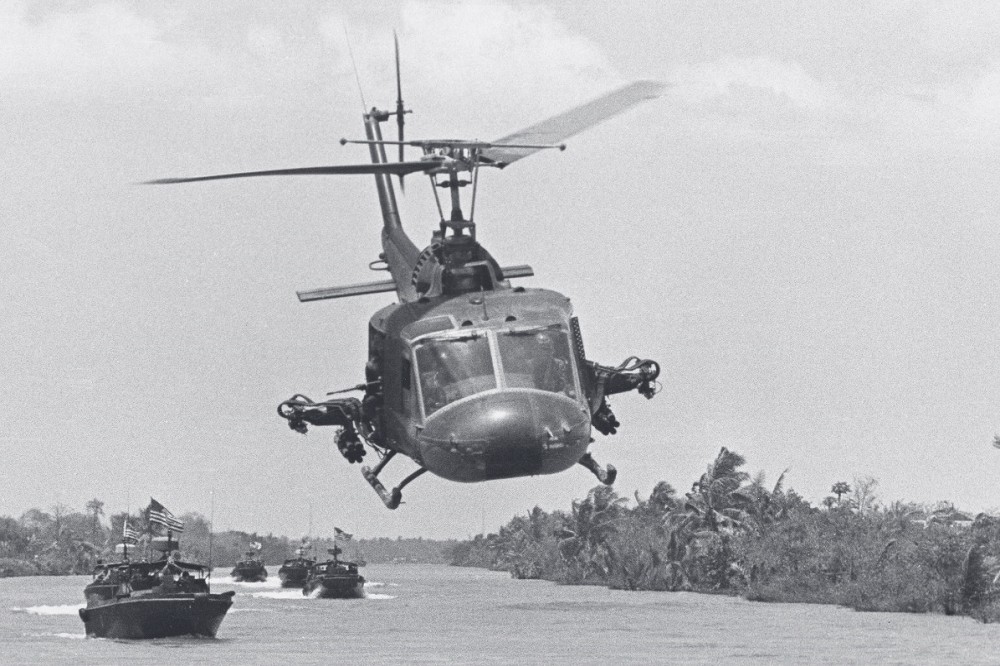 美軍直升機在越戰期間，為在河道上進行巡邏的小艇提供空中支援。